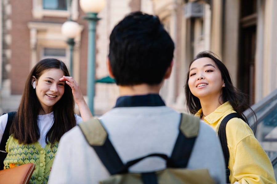 Students talking together near a university building